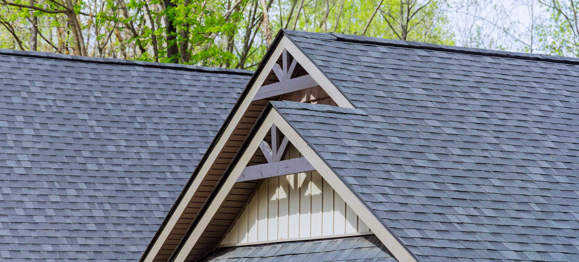 Close-up of architectural asphalt shingles showing dimensional layering and granule texture