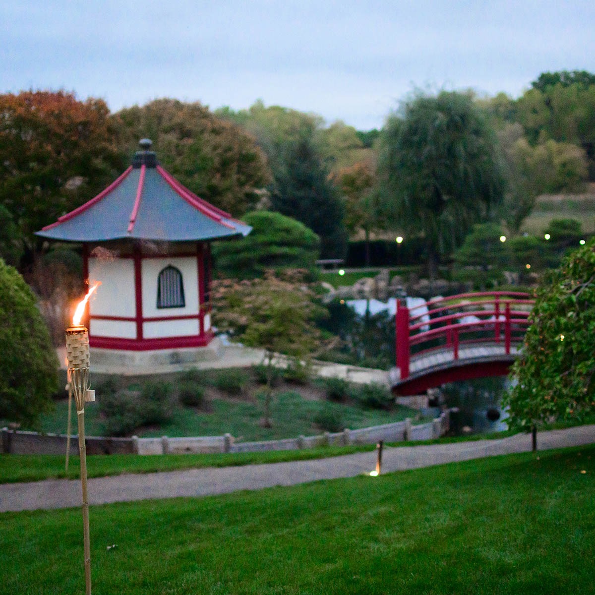 Arched red bridge and koi pond at the Normandale Japanese Garden in Bloomington on a summer afternoon