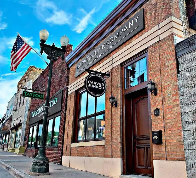 Historic brick storefronts in downtown Chaska on a summer afternoon