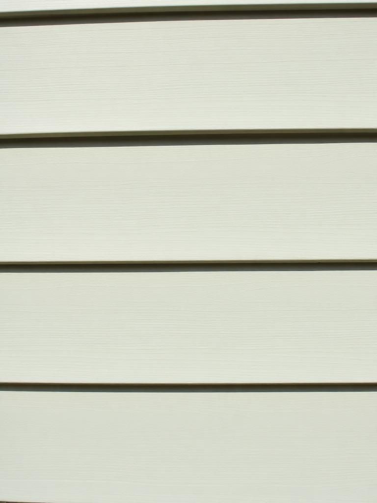Close-up of vinyl siding installed by Prominent Roofing